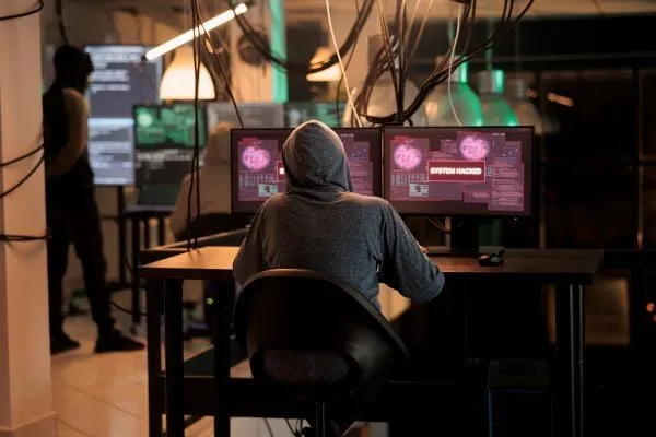 Glowing computer monitors in a darkened room