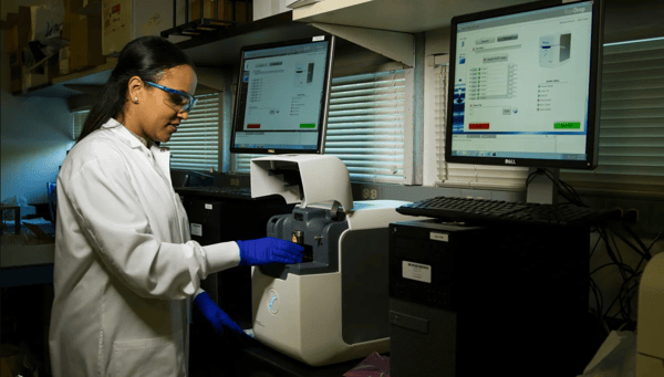 pharmaceutical researcher working with secure shared data