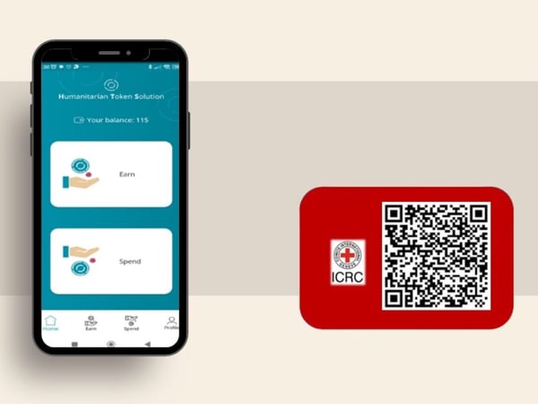Illustration of a smartphone displaying a humanitarian token wallet next to a QR code card with the ICRC logo, representing digital aid and secure token-based payments.