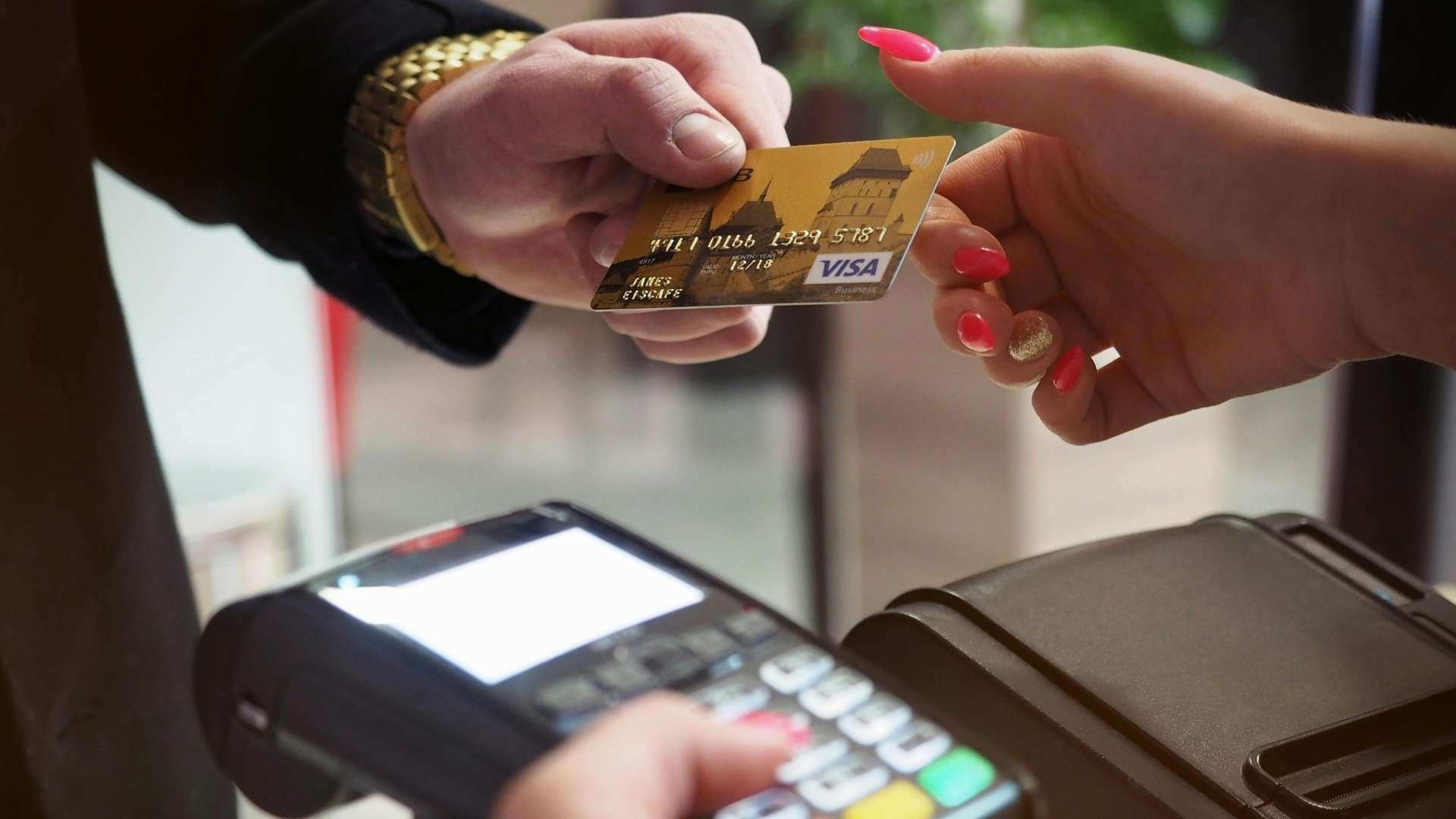 Close-up of a credit card payment at a point-of-sale terminal, illustrating secure transactions for financial institutions using multi-party computation.