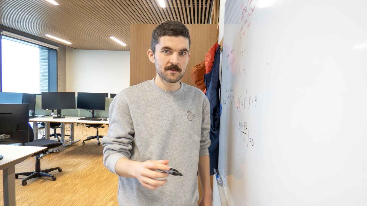 Cryptographer explaining multi party computation in front of a whiteboard