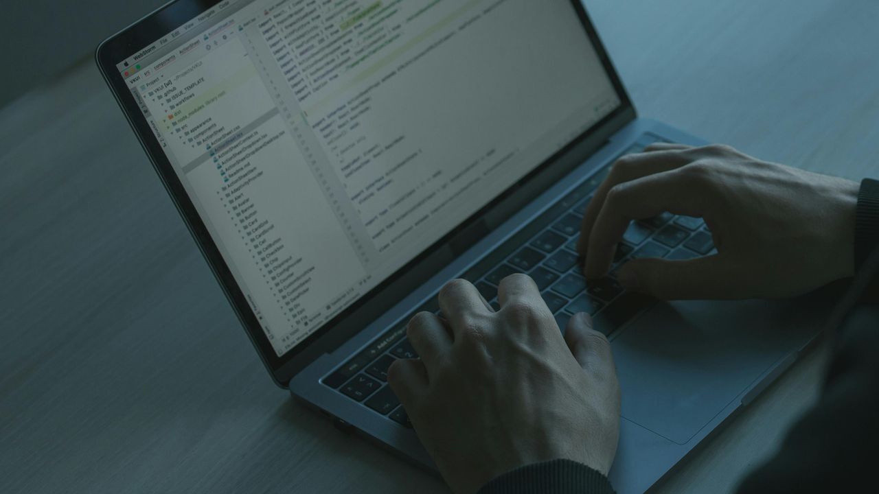person in a bank detecting financial fraud on a laptop