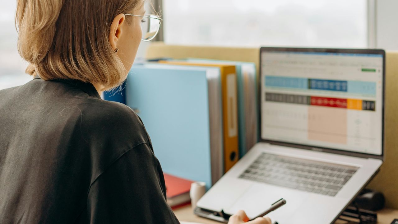 person in front of laptop doing clinical research with secure data sharing