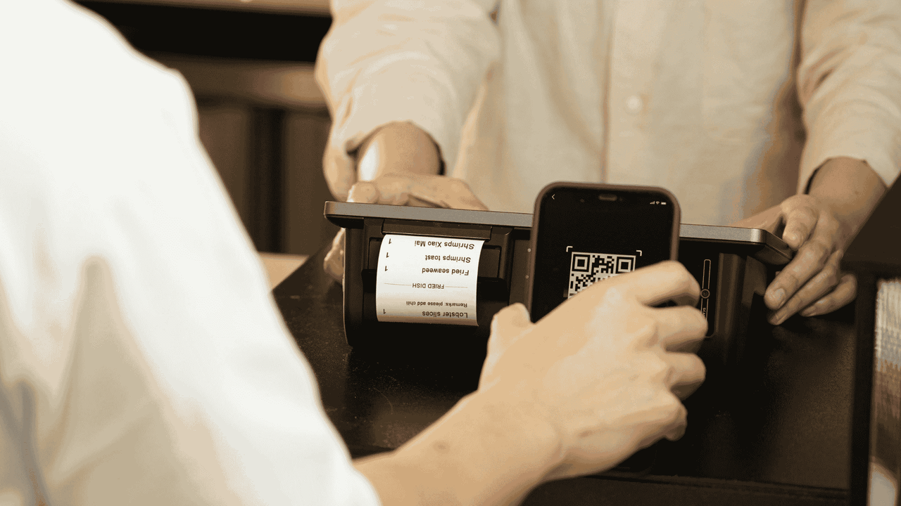 Person in a shop verifying identity using a mobile device with eIDAS 2.0
